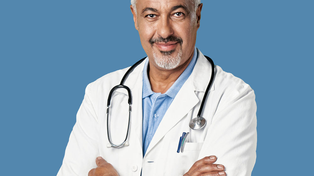 A portrait of male healthcare professional smiling