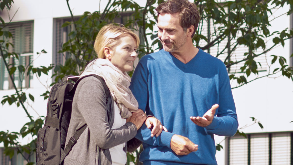 A middle-aged couple is taking a walk