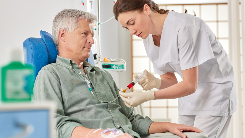 Nurse gives medication to sitting patient via syringe