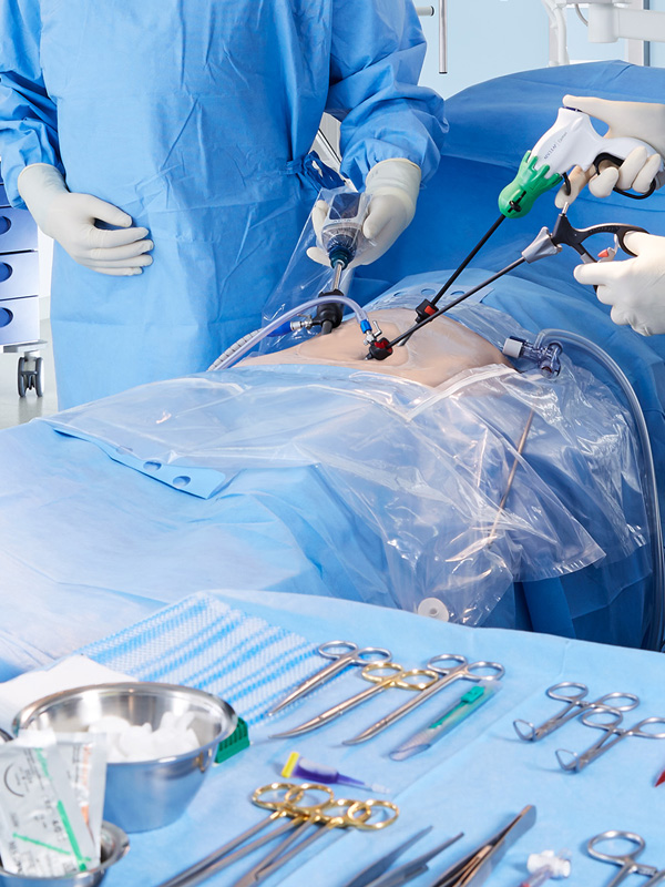 Two healthcare professionals performing laparoscopic surgery using finely curved instruments, with a focus on precision and minimally invasive techniques