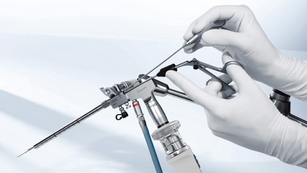 Hands of a medical worker adjusting an endoscopic device