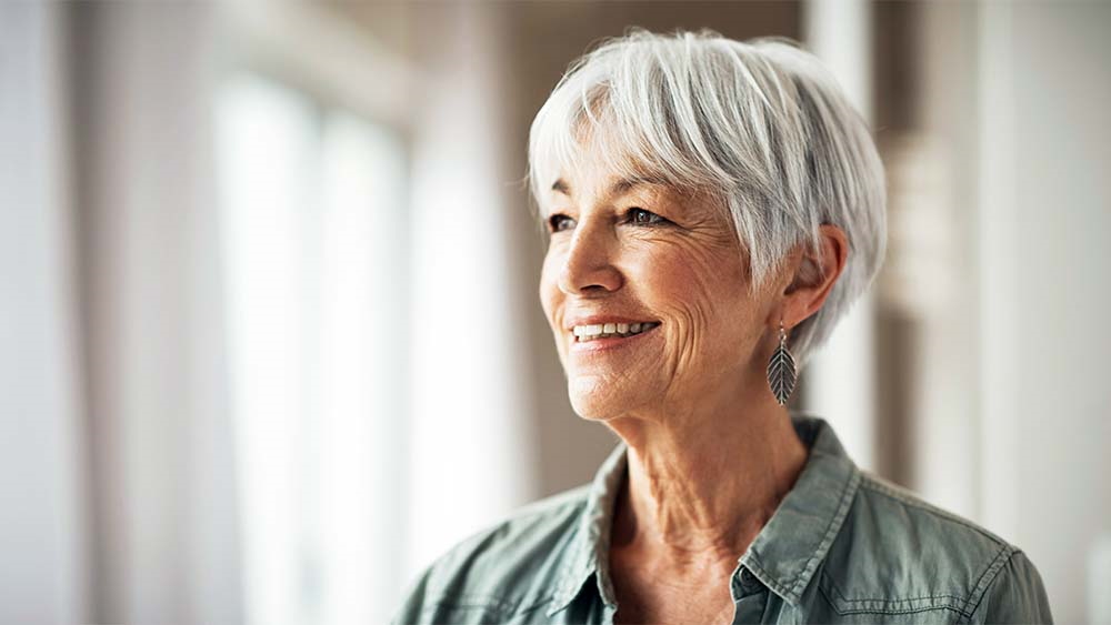 An elderly patient smiles. She looks happy